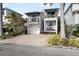 Two-story white home with balconies and a brick driveway at 110 46Th St, Holmes Beach, FL 34217