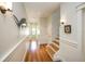 Bright hallway with hardwood floors, wainscoting, and a stairway at 110 46Th St, Holmes Beach, FL 34217