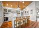 Bright kitchen featuring white cabinets, stainless steel appliances, and hardwood floors at 110 46Th St, Holmes Beach, FL 34217