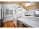 Modern kitchen with white cabinets, quartz countertops, and stainless steel appliances at 110 46Th St, Holmes Beach, FL 34217