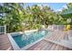 Inviting pool with a large deck and lush tropical landscaping at 110 46Th St, Holmes Beach, FL 34217