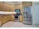 Modern kitchen with stainless steel appliances and wood cabinets at 1152 Beachcomber Ct # 15, Osprey, FL 34229