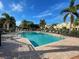 Community pool with lounge chairs and patio area at 1152 Beachcomber Ct # 15, Osprey, FL 34229