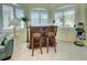 Sunroom wet bar with wood bar and two bar stools at 1152 Beachcomber Ct # 15, Osprey, FL 34229