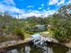 Beautiful home with screened pool and dock on canal with mature landscaping at 121 Holly Ave, Sarasota, FL 34243