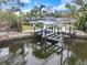 Aerial shot of a covered boat dock on the canal behind the home at 121 Holly Ave, Sarasota, FL 34243