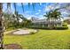 Expansive backyard with a circular patio and a screened-in pool enclosure at 121 Holly Ave, Sarasota, FL 34243