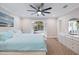 Bedroom featuring a ceiling fan, crown molding, and screened patio access at 121 Holly Ave, Sarasota, FL 34243