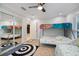 Bedroom featuring bunk beds, mirrored closet doors, and a ceiling fan at 121 Holly Ave, Sarasota, FL 34243