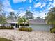 Beautiful single Gathering home with well manicured lawn, brick paver driveway, a screened porch, and two car garage at 121 Holly Ave, Sarasota, FL 34243