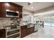 Modern kitchen with stainless steel appliances, dark wood cabinets, and granite countertops at 121 Holly Ave, Sarasota, FL 34243