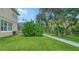 Landscaped backyard with lush greenery and a paved walkway at 12471 Natureview Cir, Bradenton, FL 34212