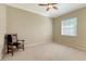 Light and airy bedroom with carpeted floor and wooden chair at 12471 Natureview Cir, Bradenton, FL 34212