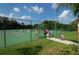 Tennis court with players enjoying a game on a sunny day at 12471 Natureview Cir, Bradenton, FL 34212