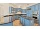 Modern kitchen with blue cabinets at 129 12Th E Ave, Palmetto, FL 34221