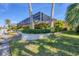 Screened-in pool area with lush landscaping at 129 12Th E Ave, Palmetto, FL 34221