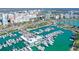 Stunning aerial view of a marina complex with luxury yachts and condominiums surrounded by the turquoise ocean at 1350 Main St # 1410, Sarasota, FL 34236