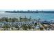 Picturesque aerial view of a marina featuring an array of boats docked amidst waterfront buildings and lush greenery at 1350 Main St # 1410, Sarasota, FL 34236