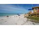 Inviting beach scene featuring a lifeguard tower, sunbathers, and clear waters under a blue sky at 1350 Main St # 1410, Sarasota, FL 34236