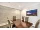 Dining room featuring a dining table, grey upholstered chairs, and decorative tile accent wall at 1350 Main St # 1410, Sarasota, FL 34236