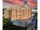 Elegant high-rise condominium building featuring a tower and multiple balconies overlooking a city street with palm trees at 1350 Main St # 1410, Sarasota, FL 34236