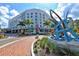 A modern hotel exterior with palm trees and an artistic sculpture featured prominently in the front at 1350 Main St # 1410, Sarasota, FL 34236