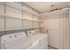 Laundry room with shelves, washer and dryer at 1350 Main St # 1410, Sarasota, FL 34236