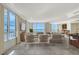 Well-lit living room with modern furniture, large windows offering stunning views, and tile flooring throughout at 1350 Main St # 1410, Sarasota, FL 34236