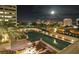 Rooftop pool with city views at night and lounge seating at 1350 Main St # 1410, Sarasota, FL 34236