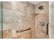 Walk in shower with neutral toned tile, grab bar, and shower head at 1350 Main St # 1410, Sarasota, FL 34236