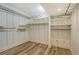 Spacious walk-in closet with multiple shelving and railing systems at 1350 Main St # 1410, Sarasota, FL 34236