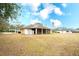 Home exterior showcasing screened patio and yard at 13609 2Nd Ne Ave, Bradenton, FL 34212