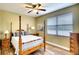 Charming bedroom with a wooden post bed and plenty of natural light at 13609 2Nd Ne Ave, Bradenton, FL 34212