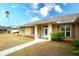 House exterior featuring a tan-colored house with a walkway leading to the front door at 13609 2Nd Ne Ave, Bradenton, FL 34212