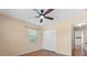 Bedroom with tile floors, ceiling fan, and double door closet at 13995 Mossy Hammock Ln, Myakka City, FL 34251