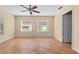 Spacious bedroom with tile floors and ceiling fan at 13995 Mossy Hammock Ln, Myakka City, FL 34251