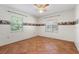 Bedroom with tile floors and ceiling fan at 13995 Mossy Hammock Ln, Myakka City, FL 34251