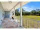 Front porch view overlooking a large grassy backyard at 13995 Mossy Hammock Ln, Myakka City, FL 34251