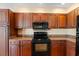 Kitchen with granite counters and wood cabinets at 13995 Mossy Hammock Ln, Myakka City, FL 34251