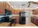 View of kitchen range, microwave and granite counters at 13995 Mossy Hammock Ln, Myakka City, FL 34251