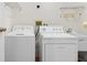 Bright laundry room with washer, dryer, and utility sink at 13995 Mossy Hammock Ln, Myakka City, FL 34251