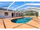 Inviting kidney-shaped pool with screened patio at 13995 Mossy Hammock Ln, Myakka City, FL 34251