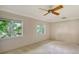 Well-lit bedroom with ceiling fan and carpet flooring at 1423 Kimlira Ln, Sarasota, FL 34231