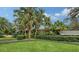 Expansive lawn with lush tropical landscaping at 1423 Kimlira Ln, Sarasota, FL 34231