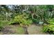 Serene garden with lush foliage, a meandering path, and a tranquil setting at 1423 Kimlira Ln, Sarasota, FL 34231