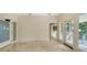 Light-filled hallway with beige walls and tile flooring at 1423 Kimlira Ln, Sarasota, FL 34231