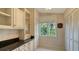 Kitchen with granite countertops, white cabinets, and window view at 1423 Kimlira Ln, Sarasota, FL 34231