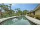 Inviting kidney-shaped pool with stone coping at 1423 Kimlira Ln, Sarasota, FL 34231