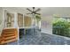 Screened porch with slate flooring and ceiling fan at 1423 Kimlira Ln, Sarasota, FL 34231