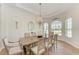 Elegant dining room with hardwood floors and large windows at 149 Montelluna Dr, North Venice, FL 34275